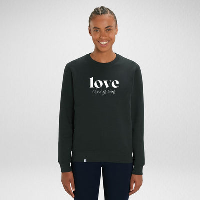 Person lächelt und trägt schwarzes Sweatshirt mit dem Aufdruck love always wins